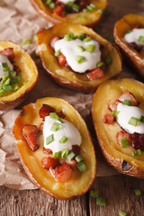 Stuffed potato skins with cheese and bacon close-up on the table. Vertical
