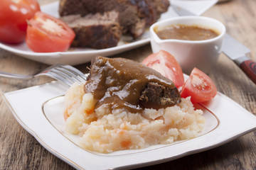 Roast beef with potato-carrot puree under the onion sauce.