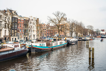 Fototapeta na wymiar Beautiful view of Amsterdam canals with bridge and typical dutch
