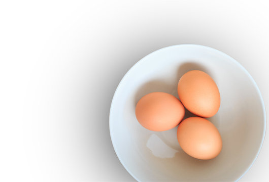 Three eggs in white plate isolated on white background.
