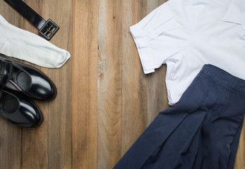 Still life : Thai Student girl uniform with wooden background on top view