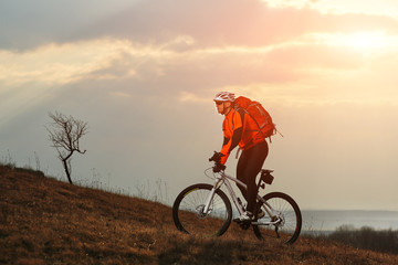 Fototapeta premium Man cyclist with backpack riding the bicycle