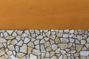 Orange divided by stones wall
