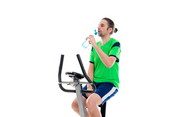 young man train with fitness machine and drinking water