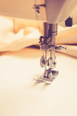 Sewing machine on fabric background vintage color