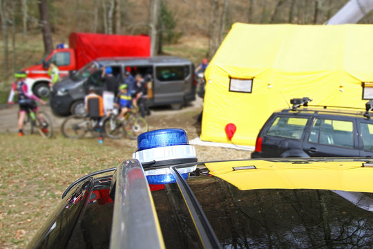 Medical care tent and vehicles at a mountain bike event 