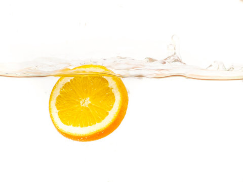 orange floating in the water on a white background