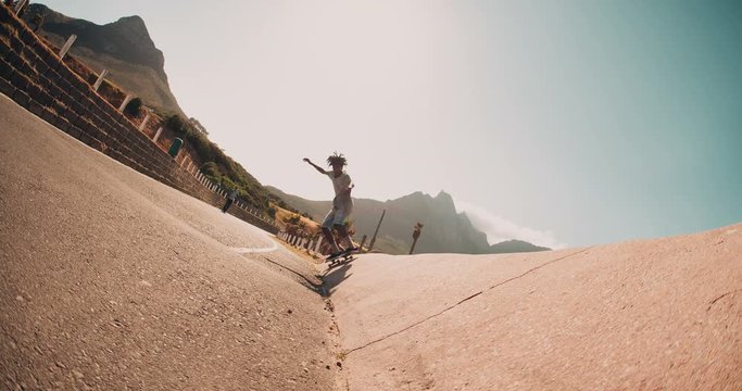 Skater Jumps off Side of Street Curb During Sunset