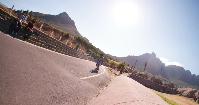 Skater Jumps off Side of Street Curb During Sunset