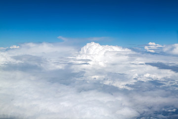 Blue sky with clouds background. View from airplane