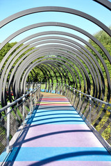 Slinky Springs Bridge. Modern bridge with multicolored gangway.
