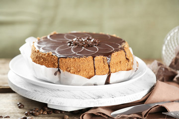 Tasty chocolate cake on wooden background