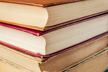 Old and used hardback books or text books seen from above.