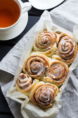 Homemade cinnabons cinnamon rolls with cream cheese glaze. Top view