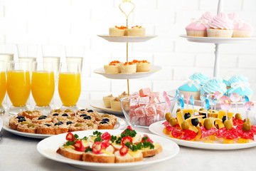 Set of cold snacks, canape, beverages and dessert, closeup