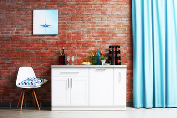 Modern kitchen furniture against brick wall background