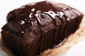 Chocolate cake with icing on white table