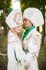Couple in ethnic clothes outdoors.