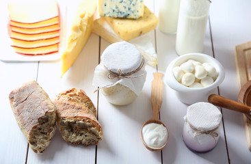 Set of fresh dairy products on white wooden table