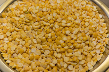 metal bowl with yellow lentils husked