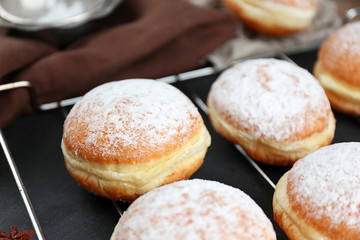 Fresh homemade donuts with powdered sugar, close up
