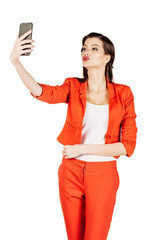 Naklejka premium business woman wearing an orange shirt using a smartphone. 