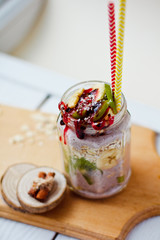 Healthy breakfast over night oats with fresh fruit kiwi and bananas in a glass jar. Beautiful oatmeal