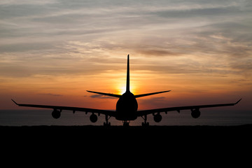  Silhouette of  passenger aircraft, airline on beautiful sunset