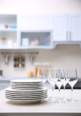 Prepared clean dishes for dinner party on a table in the kitchen