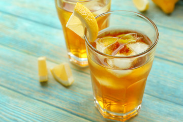 Glasses of ice lemon tea on wooden table