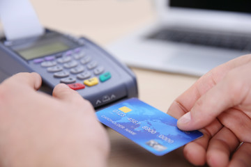 Businessman using payment terminal