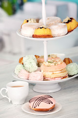 Cake stand with different sweets and tea