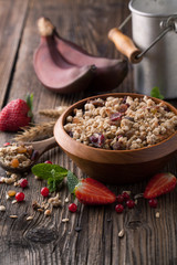 Fototapeta na wymiar Healthy breakfast of muesli with strawberries, berries, milk and