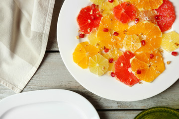 Cutting citruses on plate