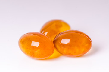 Tablets isolated on a white background. Fish oil pill. Medicine´s background. Pharmacy. Close up of capsules. 