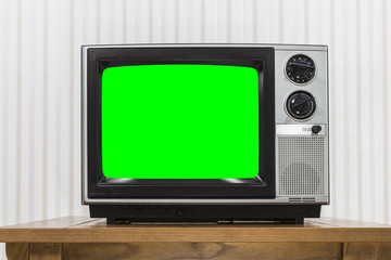 Old Portable Television on Wood Table with Chroma Key Green Scre