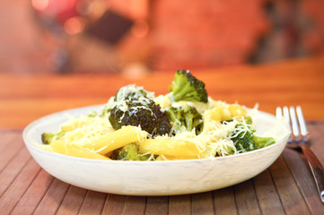 Baked broccoli and pasta with melted cheese