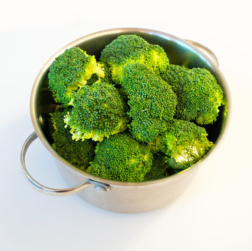 Fresh raw broccoli in casserole dish, isolated