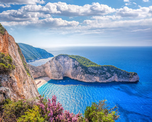 Fototapeta premium Navagio beach with shipwreck and flowers against sunset on Zakynthos island in Greece