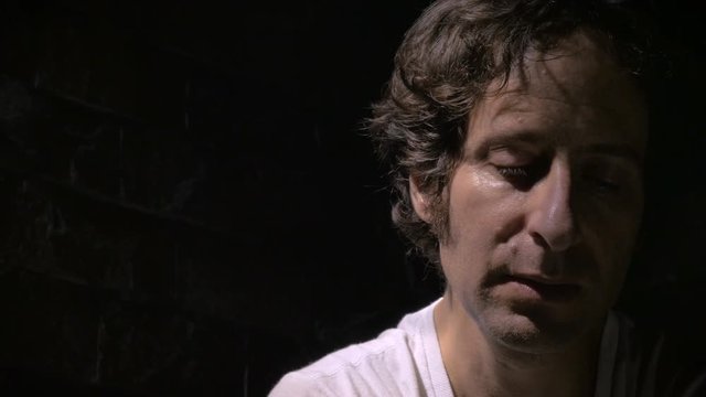 Dolly shot of a stressed out, concerned man with an internal struggle