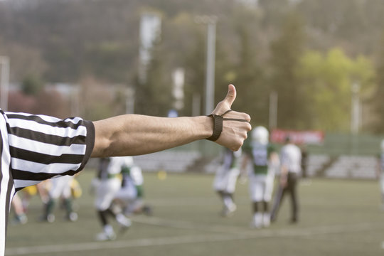 American football referee  showing thumb up