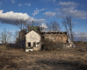 Abandoned Barn Ruin: A collapsing old white barn in a rural field in New York's Hudson Valley