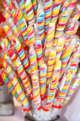 Fototapeta na wymiar Close up of colorful handmade swirl lollipop on market