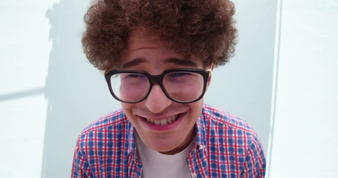 Cute young man with glasses making silly faces