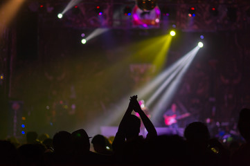 Blurred background : Club, disco DJ playing and mixing music for crowd of happy people. Nightlife,...