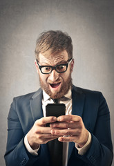 Excited businessman with smartphone
