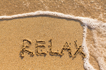 Relax - drawn on the sand of a sea beach.