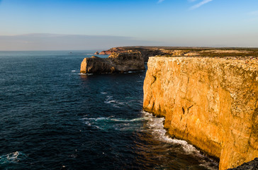 Fototapeta na wymiar cliffs and sunset, scenic view of the cliff close to the cape of san vicent, algarve portugal