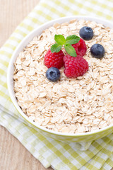 Oatmeal porridge with berries. Raspberries and blueberries.