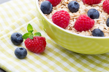 Oatmeal porridge with berries. Raspberries and blueberries.